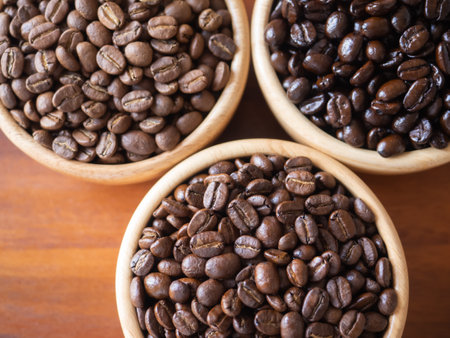brown arabica coffee bean roast 3 level medium to dark different taste seed caffeine espresso drink food cafe beverage Chiang Rai, Thailand coffee on wooden table background top view selected focusの写真素材