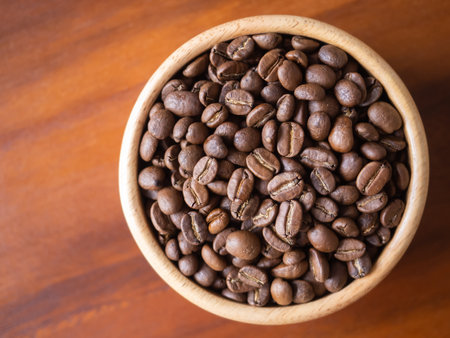 brown arabica coffee bean roast level medium taste delicate lively bright seed caffeine espresso drink food cafe beverage Chiang Rai, Thailand coffee on wooden table background top view selected focusの写真素材