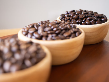 brown arabica coffee bean roast 3 level medium to dark different taste seed caffeine espresso drink food cafe beverage Chiang Rai, Thailand coffee on wooden table background top view selected focusの写真素材