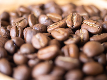 brown arabica coffee bean roast level medium taste delicate lively bright seed caffeine espresso drink food cafe beverage Chiang Rai, Thailand coffee on wooden table background top view selected focusの写真素材