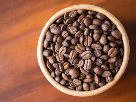 brown arabica coffee bean roast level medium taste delicate lively bright seed caffeine espresso drink food cafe beverage Chiang Rai, Thailand coffee on wooden table background top view selected focusの写真素材
