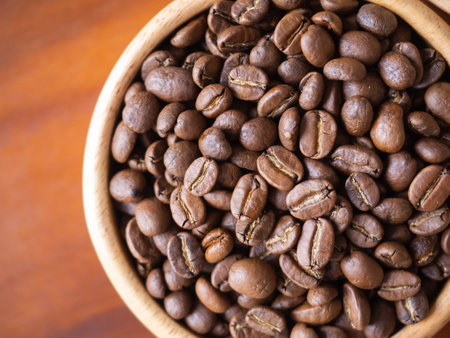 brown arabica coffee bean roast level medium taste delicate lively bright seed caffeine espresso drink food cafe beverage Chiang Rai, Thailand coffee on wooden table background top view selected focusの写真素材