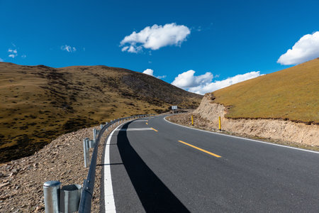 Bend on the rural road leading to Yading National Park, Daocheng, Sichuan Province, China.の写真素材