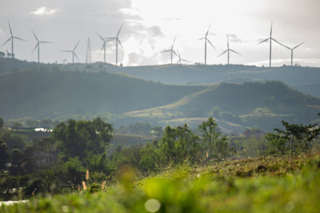 blur background of Group of windmills for renewable electric energy production. Wind turbines farm on mountains in rural areas. The clean energy system in Khao Kho District, Phetchabun, Thailand, Southeast Asia.の写真素材