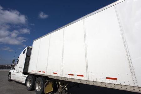 White Semi Truck parked under clouds.の写真素材