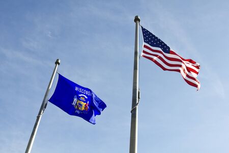 Wisconsin and USA flags waving on the windの写真素材