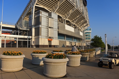 Man taking care of flowers in front of the Cleveland Browns stadiumのeditorial素材