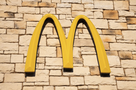 McDonald's sign on the wall of the restaurant seen day time. Joliet, Illinois, USA August 28, 2011