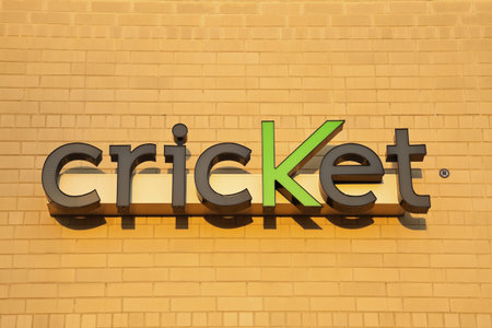 Cricket sign on the brick wall. Seen late afternoon on the new building. Cricket is a wireless company providing the services in the US. Founded in 1999. Chicago, Illinois, USA September 12, 2011のeditorial素材