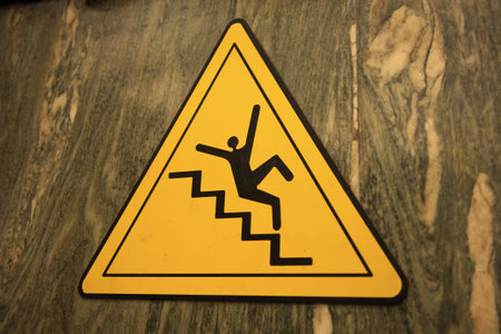 Careful on the stairs - sign in the building. Seen in Rome.