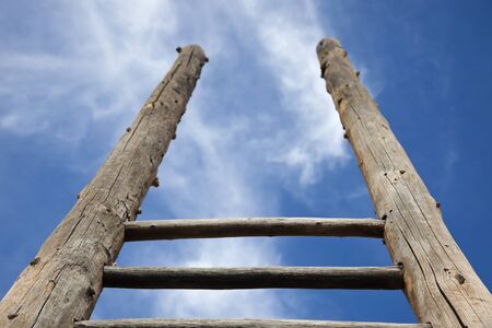 Ladder - the symbol of the career steps against blue skyの写真素材
