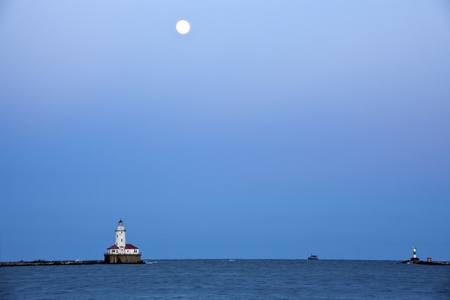 Full Moon rising above Lake Michigan and Chicago Lighthouseの写真素材