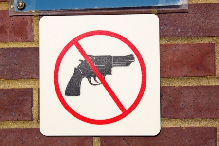 No guns sign seen on the brick wallの写真素材
