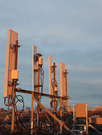 Cellular antennas on the roof in the warm sunset light