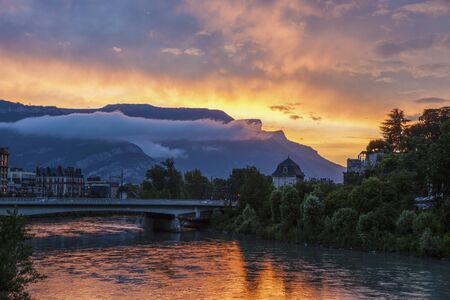 Grenoble architecture along Isere River seen at sunset. Grenoble, Auvergne-Rhone-Alpes, France.の写真素材