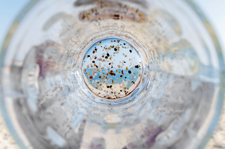 Empty bottom mug of drained fresh beer on the beachの写真素材