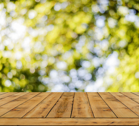 Yellow bokeh abstract light background a lot forest bokeh with wooden floorの写真素材
