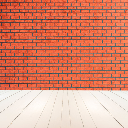 Textured red brick wall with white wooden floor insideの写真素材