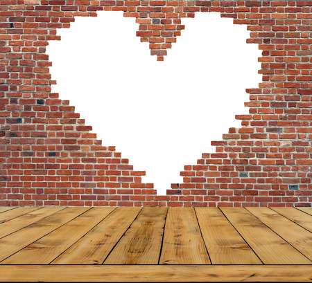 Symbol of love, brick wall heart with wooden table insideの写真素材
