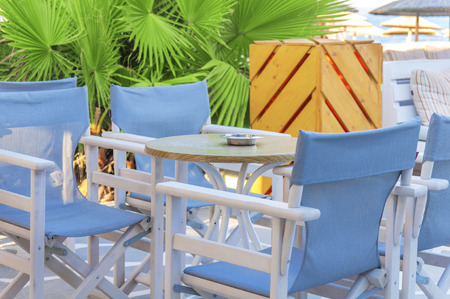 Wooden table in beach club openの写真素材