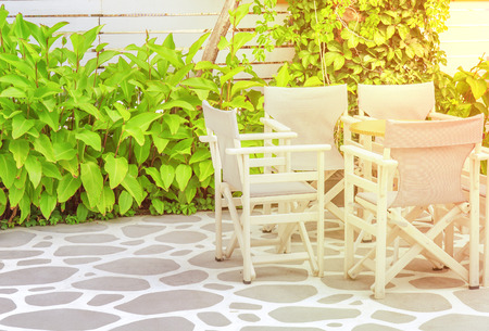 Wooden table in beach club open with burning sunの写真素材