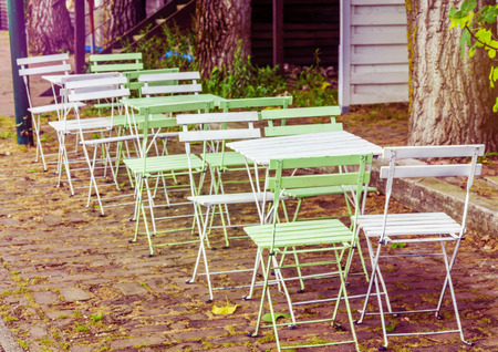 Wooden table and chair in the cafe gardenの写真素材