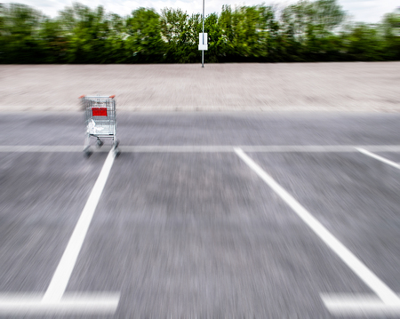 Blurry motion shopping carts on a empty parking lotの写真素材