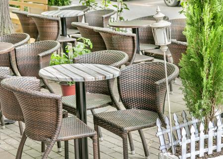 Several table and black chair in the cafe gardenの写真素材