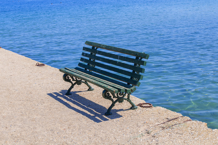 Green wooden bench on dockの写真素材