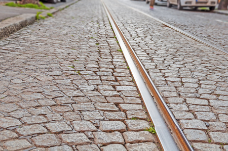 Old rail lines on cobbled road surfaceの写真素材