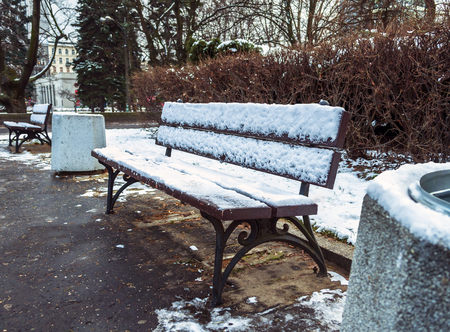 Benches in the winter city park which has been filled up with snowの写真素材