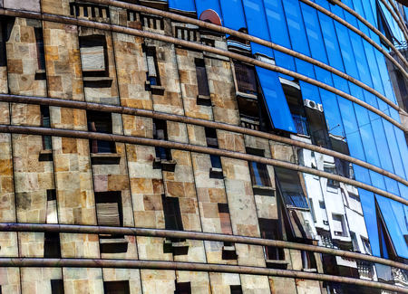 Building reflected in a mirror show-windowの写真素材