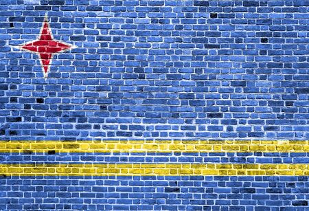 Flag of Aruba painted on brick wall, background textureの写真素材