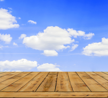 Beautifull blue cloudy sky with wooden tableの写真素材