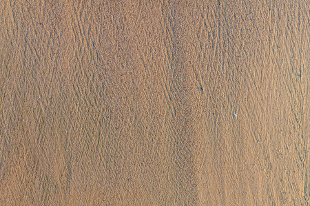 Sandy beach background, detailed sand texture, top viewの写真素材