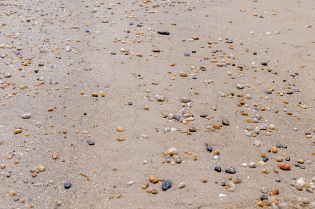 Sea pebble stone and sand texture backgroundの写真素材