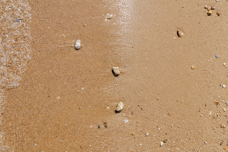 Sea pebble stone and sand texture backgroundの写真素材
