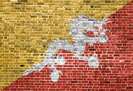 Flag of Bhutan painted on brick wall, background textureの写真素材