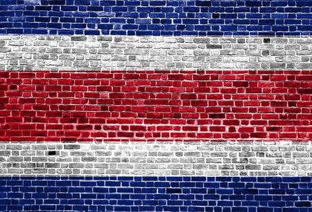Flag of Costa Rica painted on brick wall, background textureの写真素材