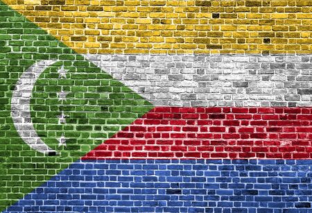 Flag of Comoros painted on brick wall, background textureの写真素材