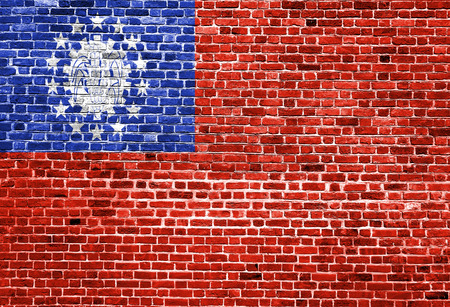 Flag of Burma painted on brick wall, background textureの写真素材