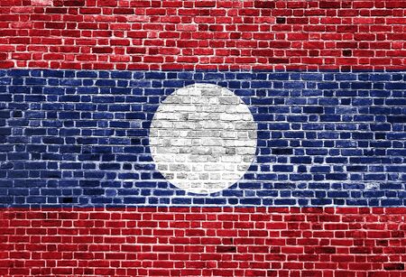 Flag of Laos painted on brick wall, background textureの写真素材