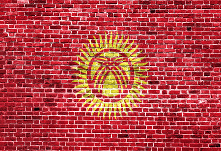 Flag of Kyrgyzstan painted on brick wall, background textureの写真素材