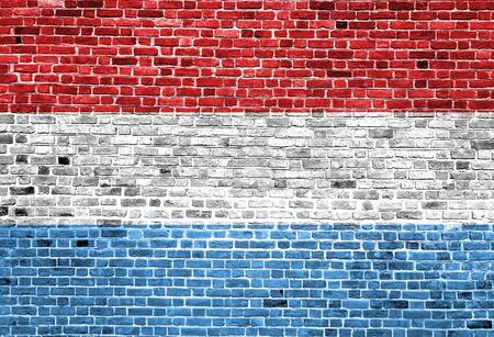 Flag of Luxembourg painted on brick wall, background textureの写真素材