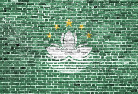 Flag of Macau painted on brick wall, background textureの写真素材