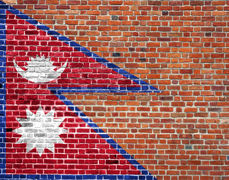 Flag of Nepal painted on brick wall, background textureの写真素材