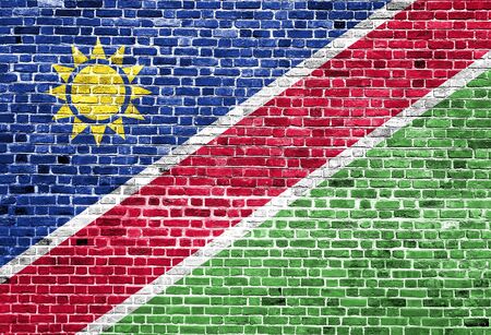 Flag of Namibia painted on brick wall, background textureの写真素材