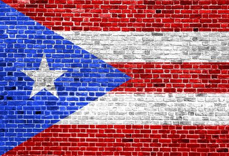 Flag of Puerto Rico painted on brick wall, background textureの写真素材