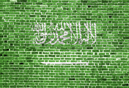 Flag of Saudi Arabia painted on brick wall, background textureの写真素材