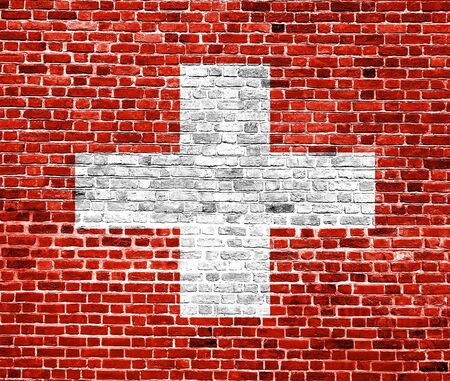 Flag of Switzerland painted on brick wall, background textureの写真素材